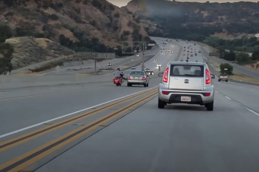 motorcyclist kicks car, chain-reaction crash