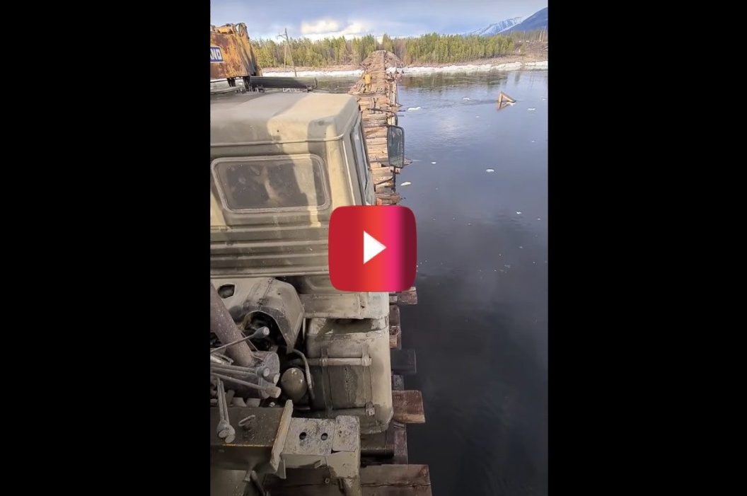 trucker drives over narrow bridge
